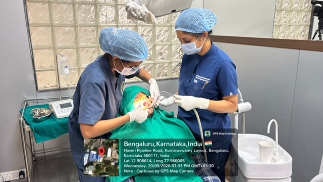 Postgraduate delegates performing live implant placement on a patient